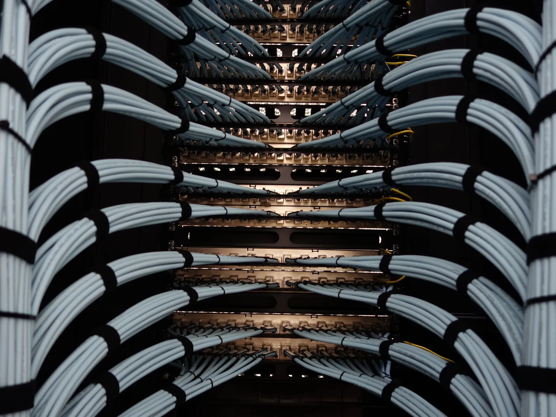 Neatly bundled network cables on both sides of a rack.