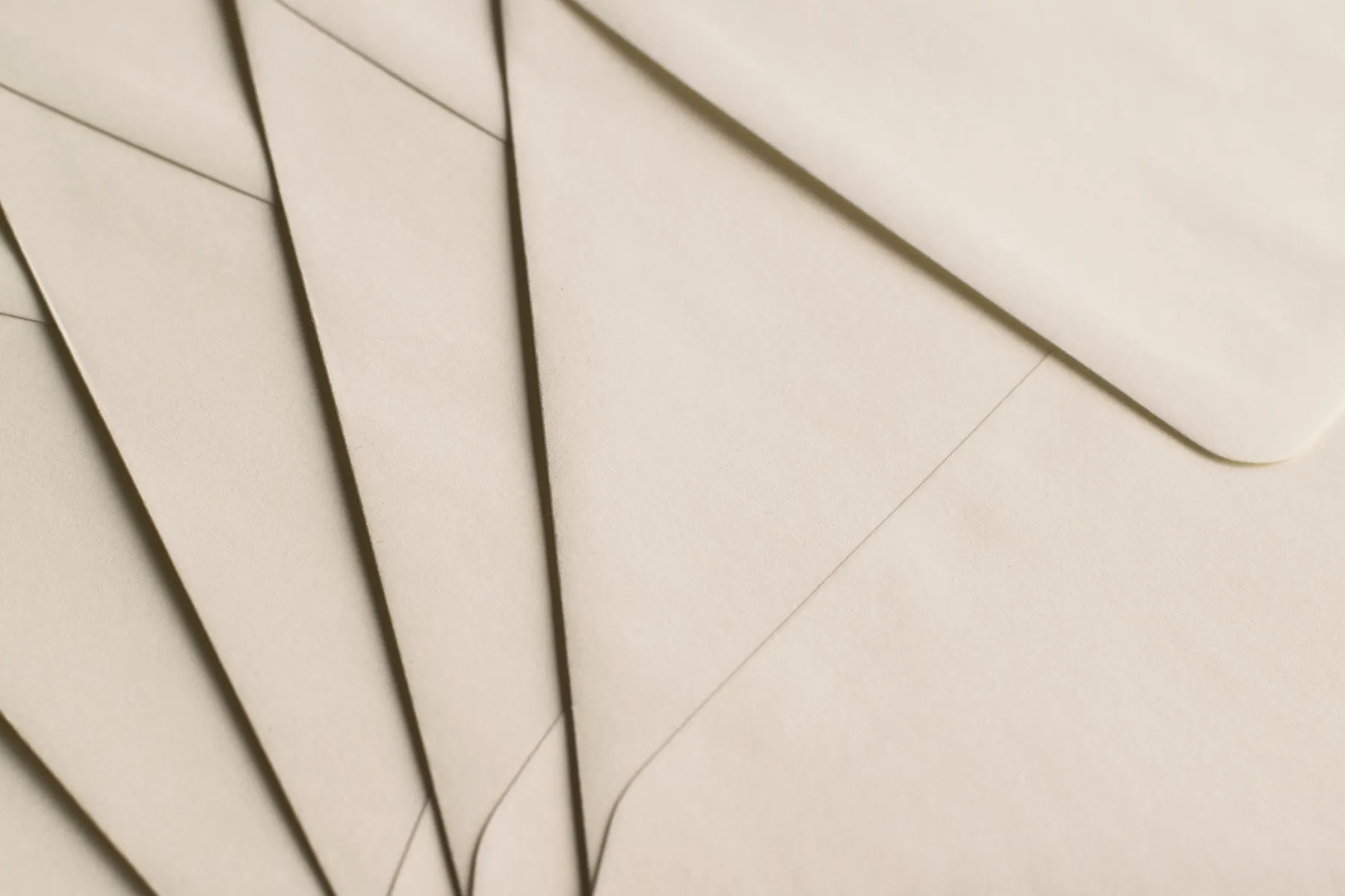 Cream envelopes fanned out, in close-up.